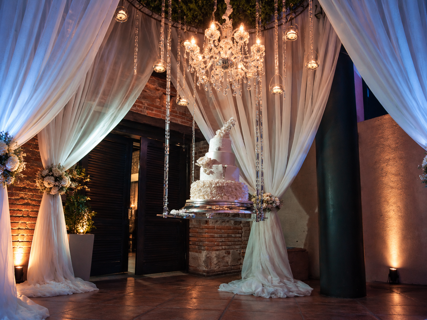 Wedding cake beneath crystal chandelier